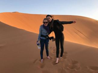 Image of doctoral student Maggie Neel in the desert (with a friend)