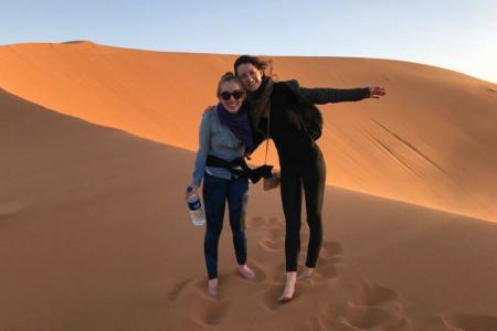 Image of doctoral student Maggie Neel in the desert (with a friend)