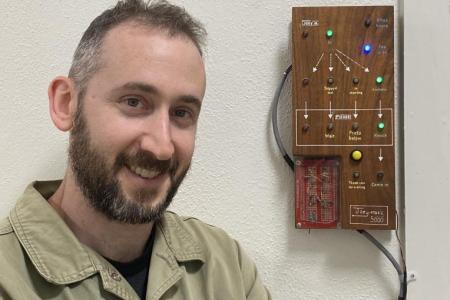 Joseph Kellner outside his office with his electronic message board