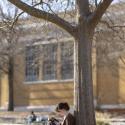 photo by UGA Marketing & Communications of undergradaute reading on North Campus outside