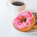 photo of a cup of coffee and donuts